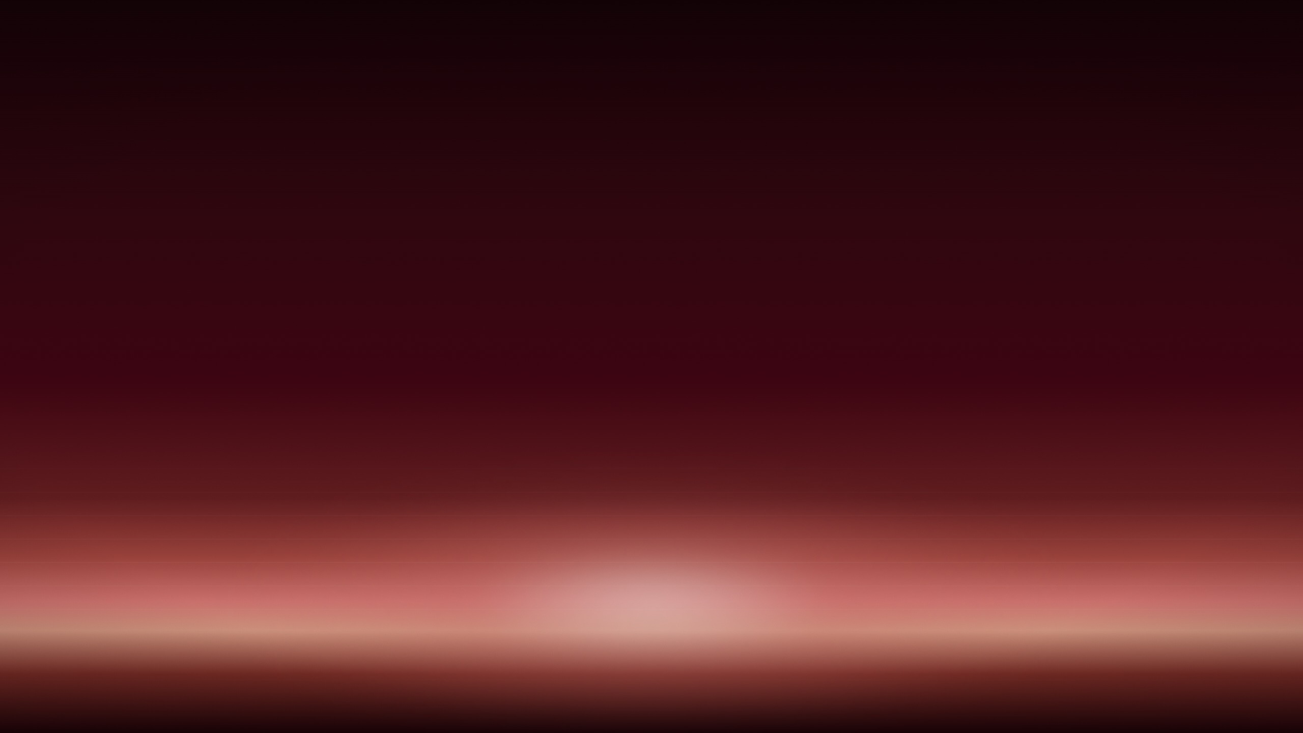 A soft band of dawn light across a deep oxblood field